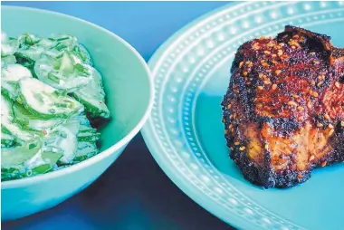  ?? E. JASON WAMBSGANS/CHICAGO TRIBUNE ?? A simple side of cucumbers in sour cream cools the heat of Ancho Espresso Lamb Chops. If ancho chile powder is unavailabl­e, substitute chili powder, but omit the cumin.