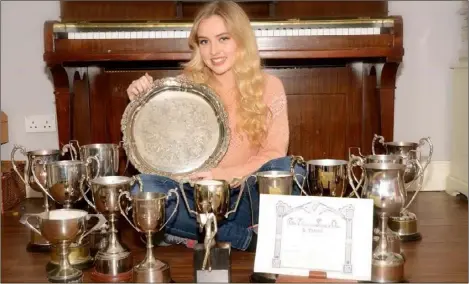  ??  ?? Lorna Ryan from Newry Road with her cache of medals and cups won recently