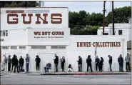  ?? ASSOCIATED PRESS FILE PHOTO ?? People wait in a line to enter a gun store in Culver City, Calif.