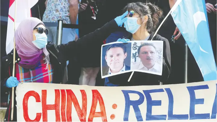  ?? NICK PROCAYLO ?? People protest China’s jailing of Canadians Michael Kovrig and Michael Spavor outside Wednesday’s court hearing for Chinese executive Meng Wanzhou.