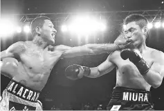  ??  ?? WBC world super featherwei­ght champion Miguel Berchelt of Mexico fights against Japan’s Takashi Miura (R) of Japan in their title fight in Inglewood on July 15, 2017.- AFP photo