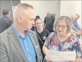  ?? THE ASSOCIATED PRESS ?? Brian Stransky, of unincorpor­ated Sarpy County, Nebraska, listens as Citizens for Voter ID campaign official Nancy McCabe reads to him from a voter ID ballot petition on Thursday at a local Republican Party meeting in Papillion, Nebraska.