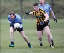  ??  ?? Shillelagh’s Keith Colliins tries to avoid Ennikserry’s Owen Corrigan during the SFL Division 3 clash at Fairgreen.