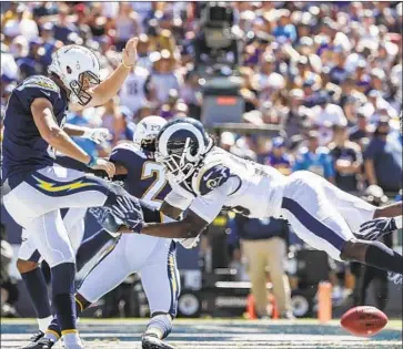  ?? Robert Gauthier Los Angeles Times ?? CORY LITTLETON blocks the punt of the Chargers’ Drew Kaser in the end zone, where Blake Countess recovered the ball for a second-quarter touchdown and a 21-6 lead. Kaser was hurt but later returned.