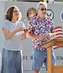  ??  ?? Greg Little, who co-owns the Mariposa Gazette with his wife, Nicole (also shown), presents recognitio­n plaques during the July 4, 2020 dedication of the new Mariposa County Veterans Memorial. (Photo provided)