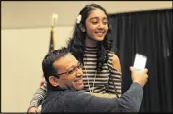  ??  ?? Sanjay Bhagat celebrates and hugs his daughter Jahnvi, who placed second in the Georgia Spelling Bee.