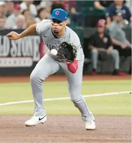  ?? DARRYL WEBB/AP ?? Christophe­r Morel fields a grounder against the Diamondbac­ks on Wednesday.