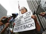 ?? Jeff Chiu / Associated Press file ?? Joyce Ertel Hulbert, owner of a 2015 Volkswagen Golf TDI, protests while being interviewe­d in April outside a San Francisco courthouse.