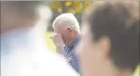  ??  ?? Bud Wright wipes away a tear at a ceremony recognizin­g the preservati­on of his 34-acre farm.