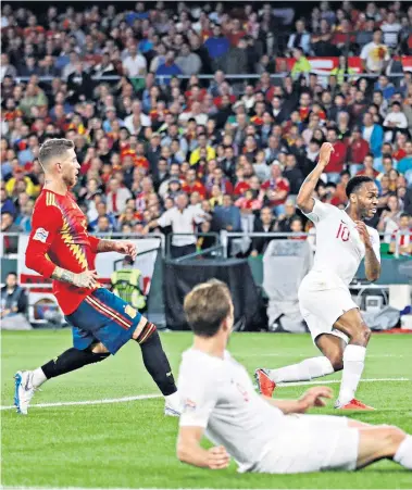  ??  ?? Three and easy: Raheem Sterling scores England’s third goal after a pull-back from Harry Kane (foreground)