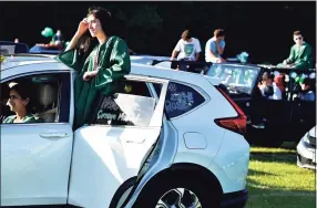  ?? Peter Hvizdak / Hearst Connecticu­t Media ?? Rose McDermott of the Guilford High School Class of 2020 listens to graduation speakers while in a car during the Covid-19 pandemic induced social-distancing drive-in movie-style graduation in June 2020 at the Guilford Fairground­s.