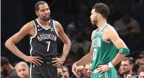  ?? (AP photo/Jessie Alcheh) ?? Brooklyn Nets forward Kevin Durant (7) interacts with Boston Celtics forward Jayson Tatum (0) Sunday during the second half of an NBA basketball game in New York.