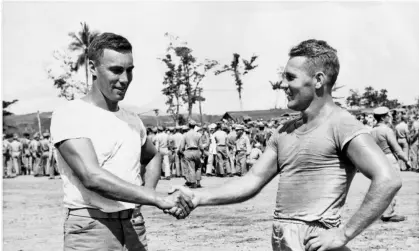  ?? ?? The handshake: Dave Schreiner and Tony Butkovich at the Mosquito Bowl. Photograph: HarperColl­ins