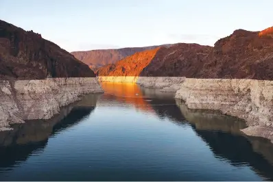  ?? The Associated Press ?? ■ A bathtub ring of light minerals shows the high water line of Lake Mead near Hoover Dam at the Lake Mead National Recreation Area on June 26 near Boulder City, Nev.