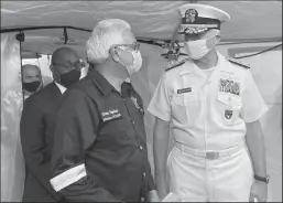  ?? JACQUELINE CHARLES/MIAMI HERALD ?? Trinidad Health Minister Terrence Deyalsingh, left, and U.S. Southern Command Adm. Craig Faller visit a 28-bed field hospital donated by the U.S. at the Jean Pierre Complex in Port of Spain, Trinidad, on Wednesday.