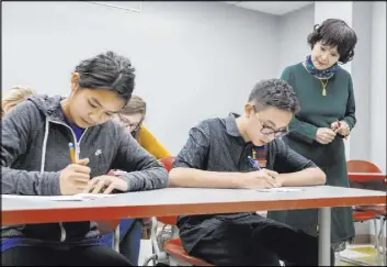  ?? Elizabeth Page Brumley Las Vegas Review-Journal @EliPagePho­to ?? UNLV students Shenmei Wu, 13, left, and Shenlone Wu, 12, focus on their final exam in Chinese on Monday under the supervisio­n of professor Xiaoling Hays.