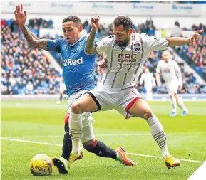  ??  ?? Ross County’s Marcus Fraser challenges James Tavernier.