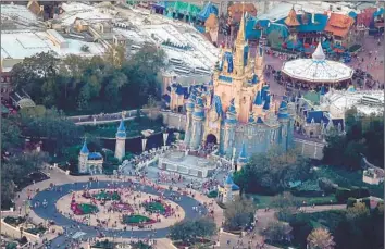  ?? JOE RAEDLE Getty Images ?? CINDERELLA CASTLE at Florida’s Magic Kingdom. Walt Disney Co., in the midst of a legal fight with Gov. Ron DeSantis, said it has canceled plans for a $1-billion campus in the state and won’t relocate 2,000 workers.