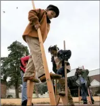  ?? Democrat-Gazette file photo/RICK McFARLAND ?? Visiting children can test their stilt skills at the Historic Arkansas Museum’s Christmas Frolic on Sunday.