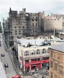  ??  ?? GRIM Daybreak revealed extent of exterior damage and firefighti­ng crews remained on the scene off Sauchiehal­l Street yesterday