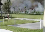  ?? Courtesy to the Miami Herald ?? A sugar cane field burns near a school in South Bay. A bill to restrict lawsuits against farmers, including the sugar growers around Lake Okeechobee, advanced in the Florida House.