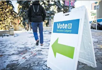  ?? GAVIN YOUNG ?? A voter heads to cast his ballot in the Olympic 2026 bid plebiscite at the Memorial Park Library.