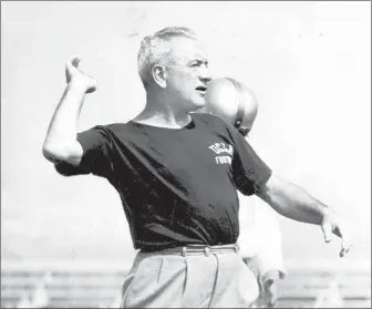  ?? Los Angeles Times file photo ?? RED SANDERS demonstrat­es passing technique during the 1954 season, when UCLA went unbeaten, led the nation in scoring and scoring defense and won its only national football championsh­ip.