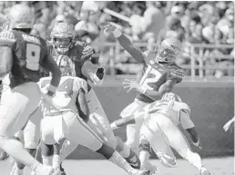  ?? JOE ROBBINS/GETTY-AFP ?? Florida State quarterbac­k Deondre Francois throws a pass while under pressure during the Seminoles’ loss to Clemson on Saturday at Doak Campbell Stadium.