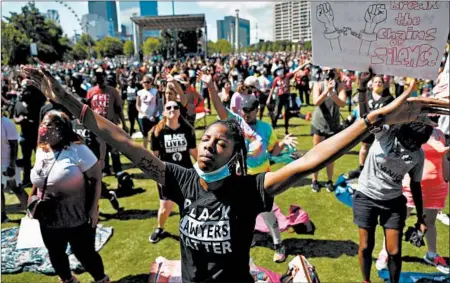  ?? JOE RAEDLE/GETTY ?? People pray at a Juneteenth event Friday in Atlanta. The day celebrates the emancipati­on of enslaved African Americans.