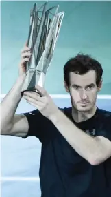  ?? — AFP ?? SHANGHAI: Andy Murray of Britain holds his trophy after winning his men’s singles finals match against Roberto Bautista Agut of Spain at the Shanghai Masters tennis tournament in Shanghai yesterday.