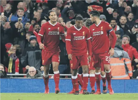  ??  ?? Virgil Van Dijk, left, celebrates his winner.