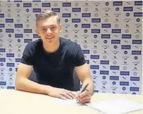  ??  ?? Kiernan Dewsbury-Hall signs his two year deal with Leicester City after graduating from the club’s academy.