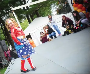  ?? Ernest A. Brown photo ?? Mikayla Boucher, 6, takes the stage dressed as Wonder Woman while competing in the “Little Miss Autumnfest” contest on the Kids’ Stage Saturday.