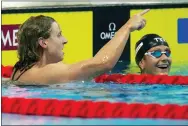  ?? DAVID JOSEK - THE ASSOCIATED PRESS ?? Katie Ledecky of the United States celebrates with Second placed Katie Grimes, right, also of the United States, after winning the Women 1500m Freestyle final at the 19th FINA World Championsh­ips in Budapest, Hungary, Monday.