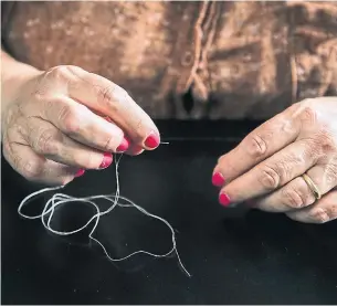  ?? GIANNI CIPRIANO PHOTOS THE NEW YORK TIMES ?? A seamstress who works for luxury brands, sews in her home kitchen in the Puglia region of Italy.