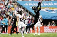  ?? IAN WALTON/AP ?? Mack Hollins (18) explains his sideline frustratio­n with quarterbac­k Desmond Ridder during the game between the Falcons and the Jaguars this past Sunday in London.