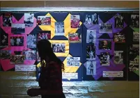  ?? ?? People look at posters of the 2020Vallej­o Sports Hall of Fame inductees during an awards dinner Saturday night.