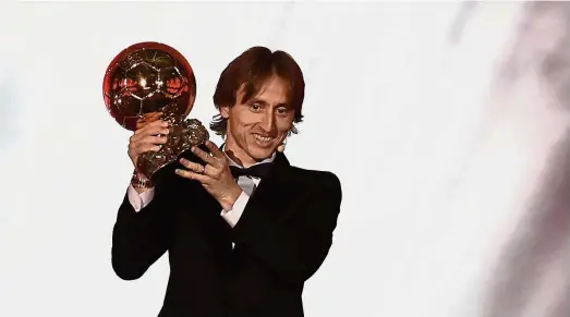  ??  ?? The ball is mine: Croatia midfielder Luka Modric holding the Ballon d’Or trophy during the award ceremony at the Grand Palais in Paris on Monday. — AFP