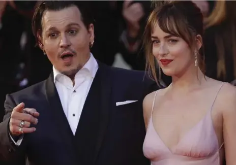  ?? DOMENICO STINELLIS/THE ASSOCIATED PRESS FILE PHOTO ?? Johnny Depp and Dakota Johnson appeared at the Venice Film Festival to promote Black Mass. They’re in Toronto doing the same.