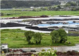  ?? — Photos: aFP ?? the collection site for contaminat­ed earth in naraha, located 20km from the tsunami- wrecked Fukushima nuclear plant.