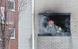  ?? PHOTOS BY MATHEW MCCARTHY WATERLOO REGION RECORD ?? Firefighte­rs work to control a fire Sunday morning on Lancaster St. W. in Kitchener.