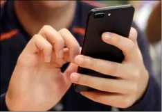  ??  ?? In this Friday file photo, a person uses a smart phone in Chicago. A new analysis suggests that increased social media use could be one factor contributi­ng to a rise in teen suicide. AP PHOTO