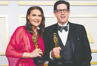  ?? CHRIS PIZZELLO/REUTERS ?? Producer Alice Doyard and director Anthony Giacchino celebrate their Oscar win for Colette, a short documentar­y about French resistance fighter Colette Marin-catherine, left.