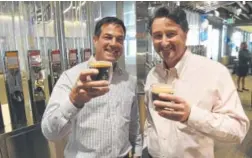  ??  ?? Roasting Plant co-founders Thomas Hartocolli­s, above left, and Mike Caswell toast their location at Denver Internatio­nal Airport on Tuesday. The shop, left, sits next to the transit center near the University of Colorado A-Line platform.