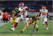  ?? AP FILE PHOTO BY MARCIO JOSE SANCHEZ ?? In this 2018 photo, Kansas City Chiefs running back Kareem Hunt (27) scores a touchdown ahead of Los Angeles Rams free safety Lamarcus Joyner (20) as Chiefs offensive guard Cameron Erving (75) looks on during the first half of an NFL football game, in Los Angeles.