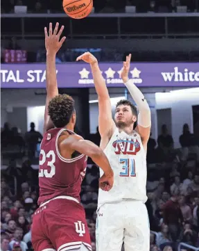  ?? NAM Y. HUH/AP ?? Northweste­rn forward Robbie Beran shoots over Indiana forward Trayce Jackson-Davis on Wednesday in Evanston, Illinois.