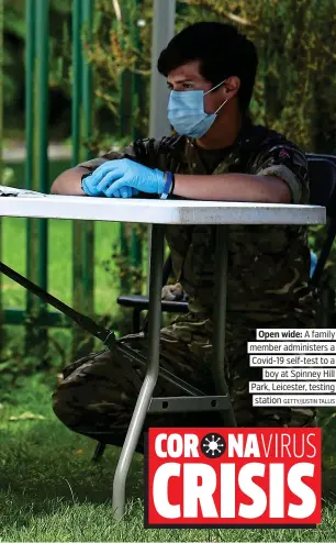  ?? GETTY/JUSTIN TALLIS ?? Open wide: A family member administer­s a Covid-19 self-test to a boy at Spinney Hill Park, Leicester, testing station