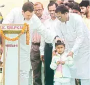  ??  ?? Congress President Rahul Gandhi interacts with a child at a programme at Majhagava village of Amethi on Tuesday