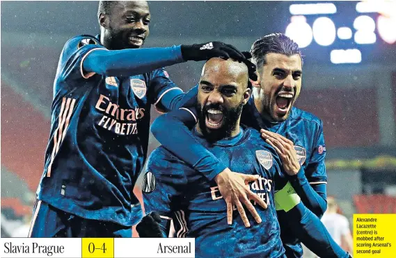  ??  ?? Alexandre Lacazette (centre) is mobbed after scoring Arsenal’s second goal