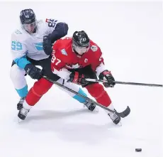  ?? TOM SZCZERBOWS­KI/GETTY IMAGES ?? Canada’s Sidney Crosby is hounded by Europe’s Roman Josi, who leads all World Cup of Hockey defencemen in icetime and was fourth among NHL defencemen in scoring last season.